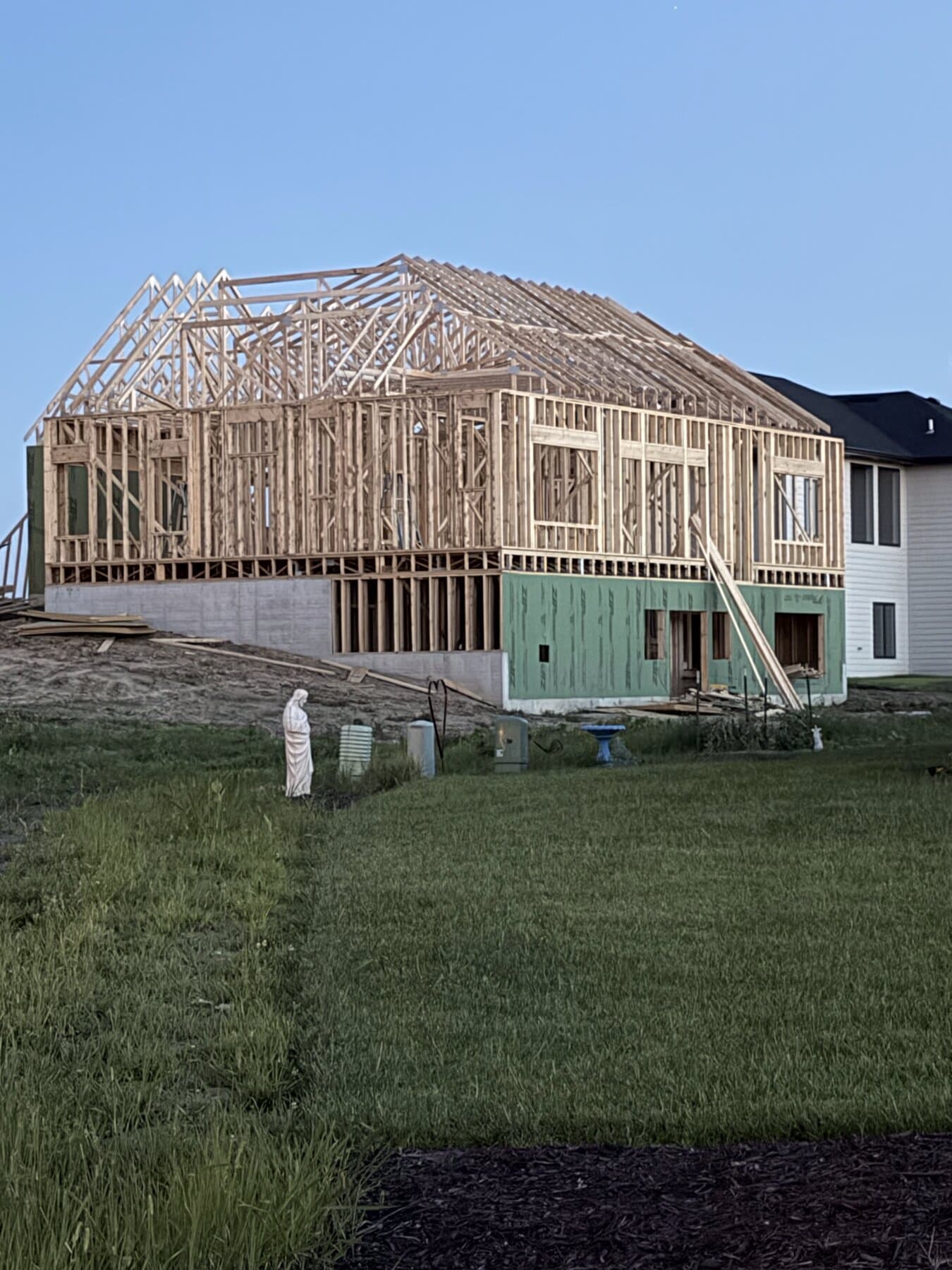 Full frame construction with roof trusses set at dusk